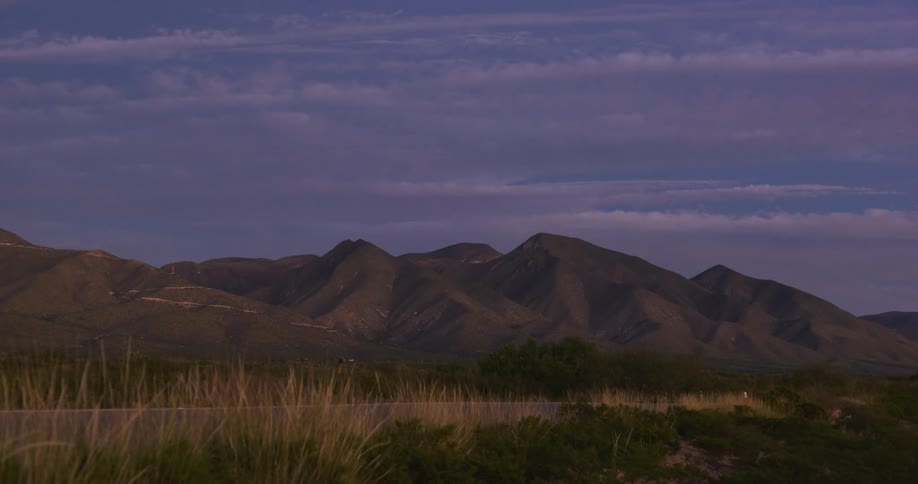 Sun is setting above the mountain tops during spring