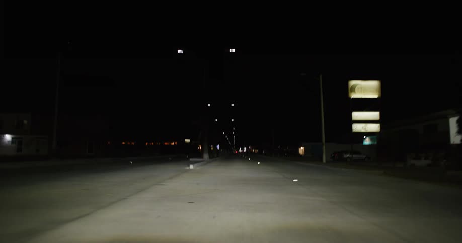 The road is lined with lamp posts