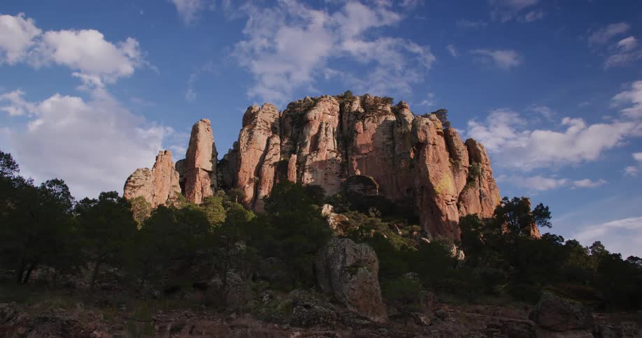 Hill with canyons overlooking the blue sky with clouds