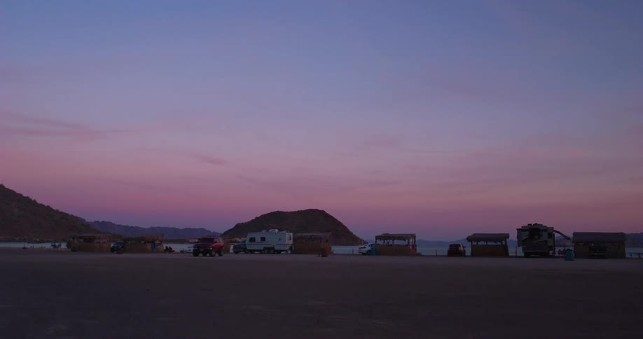 Vehicles are all parked on the beach