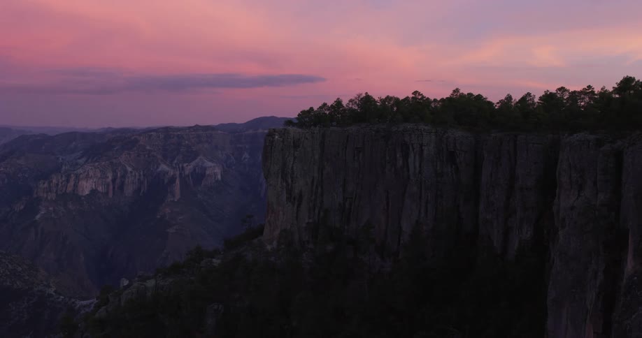 Large cliffs and mountains loom over the surrounding area