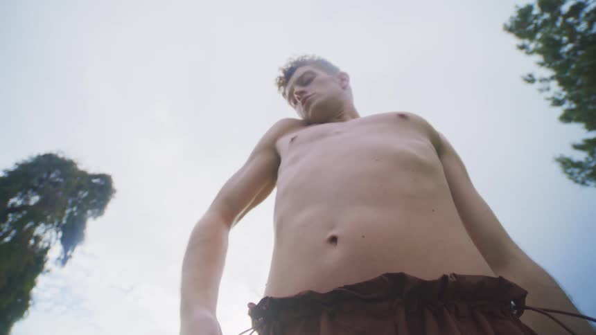 A young man stretches outdoors