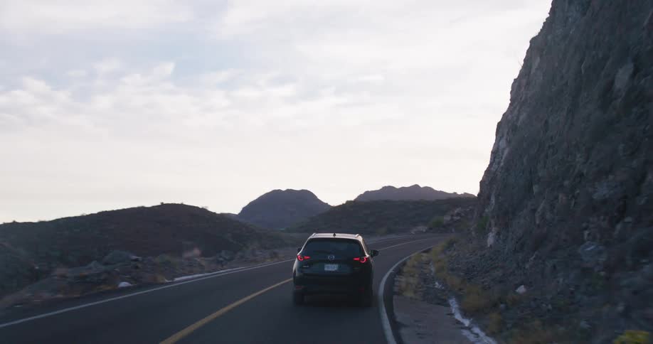 A car drives on the highway near the shore