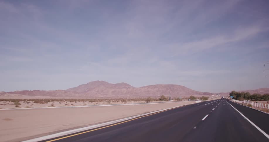Traffic moves along a highway that runs through a desert