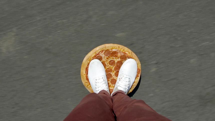Someone riding a pizza shaped skateboard
