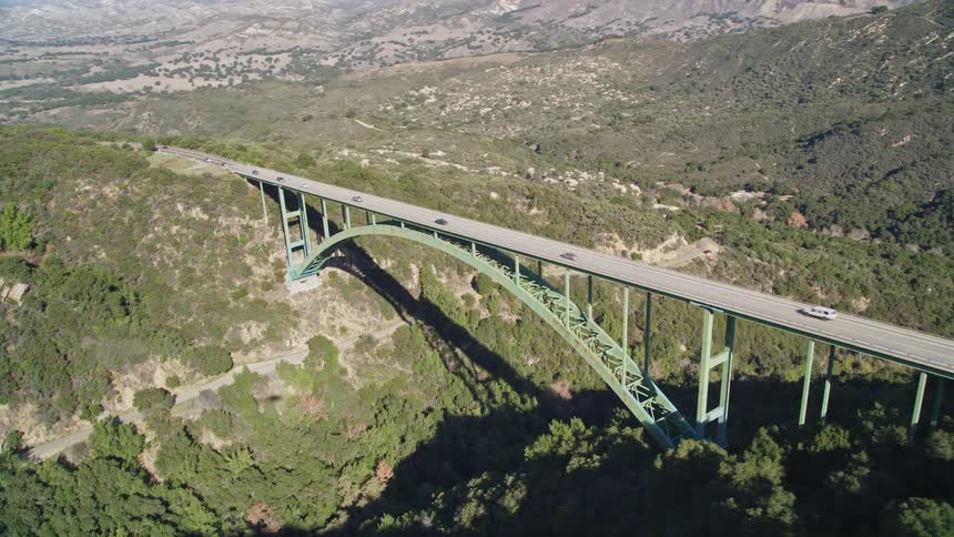 Traffic flows over the bridge on the mountains