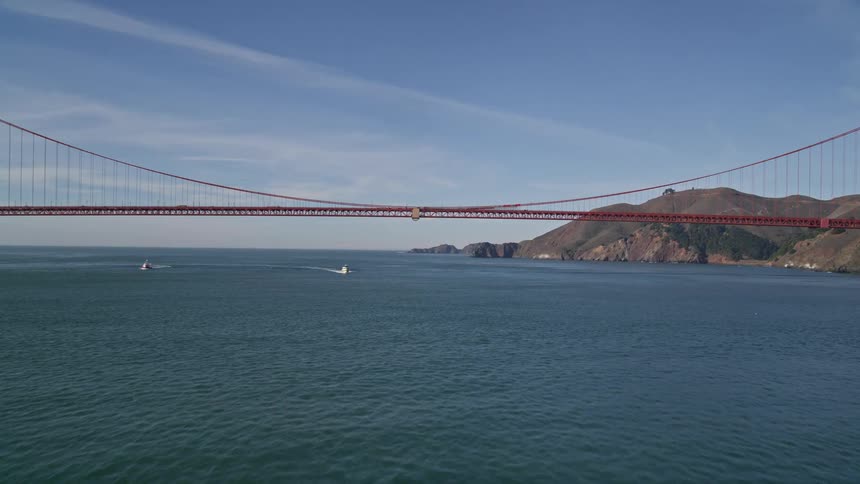 A long red bridge covers the water