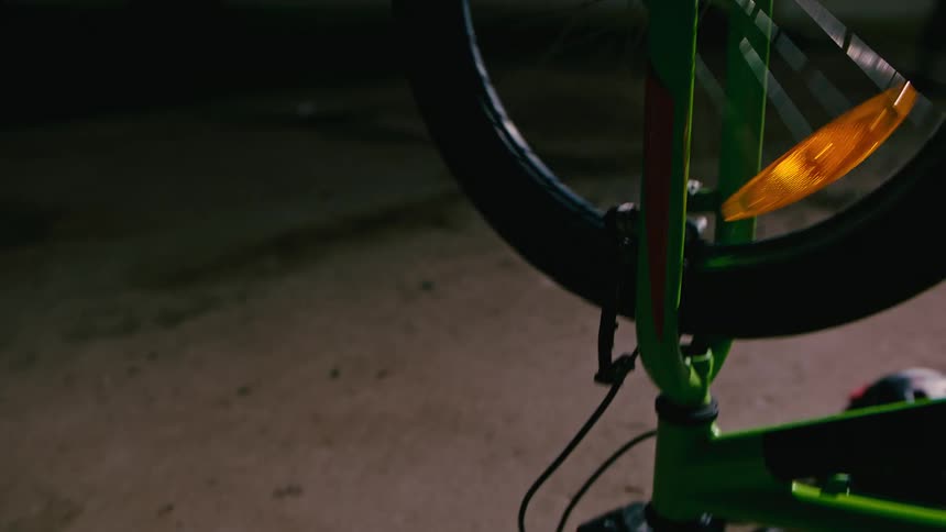 A boy is spinning the tires on his bicycle