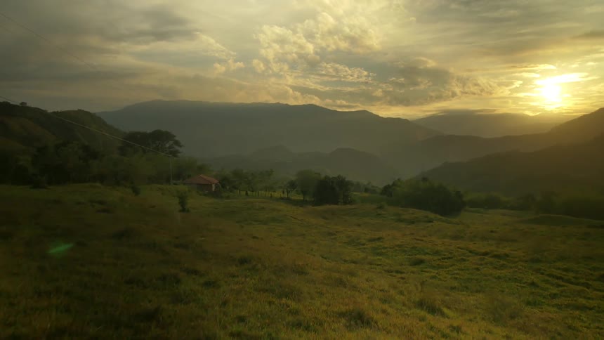 The sun goes down behind a mountain range