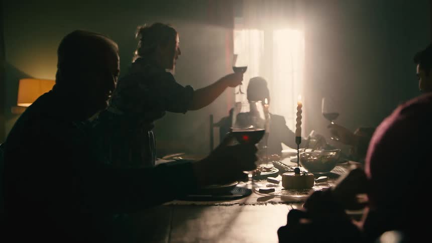 A group of people enjoy some wine at a dinner table