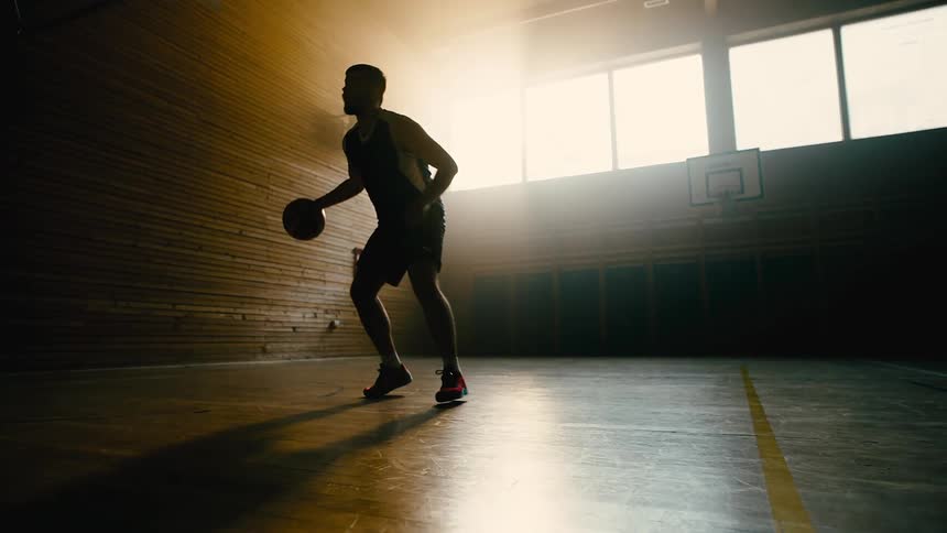 A man does a lay up on a basketball court