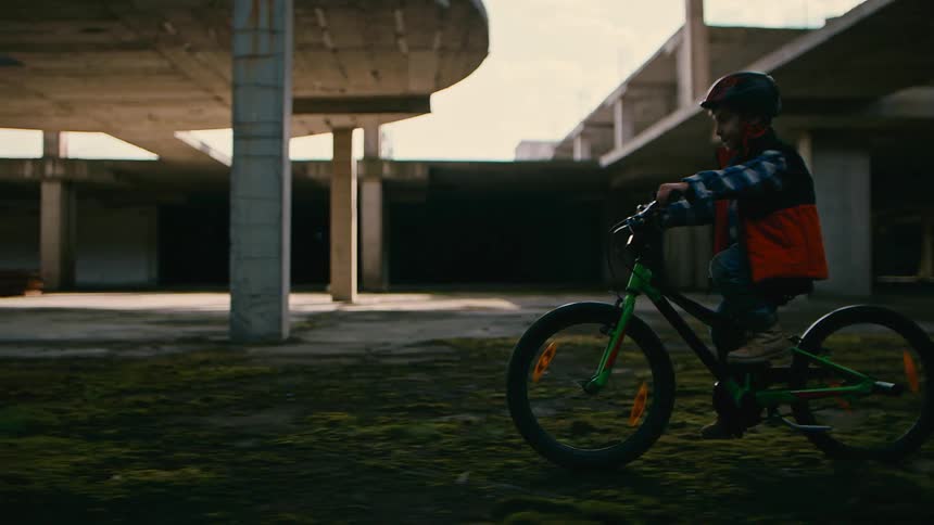 A child is riding his bicycle