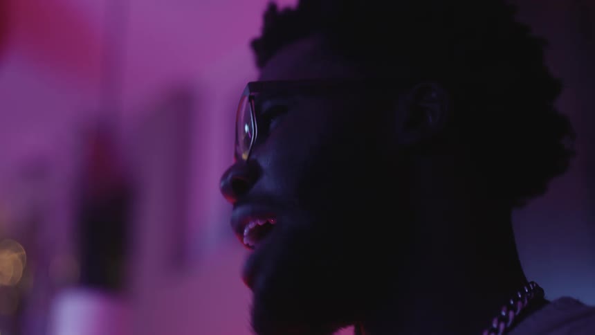 A man is smiling as he talks