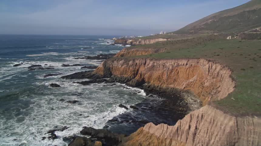 Waves crash against coastal cliffs