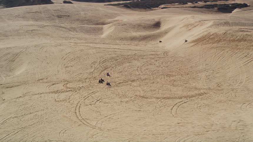 Bmx bikes are driving in the sand
