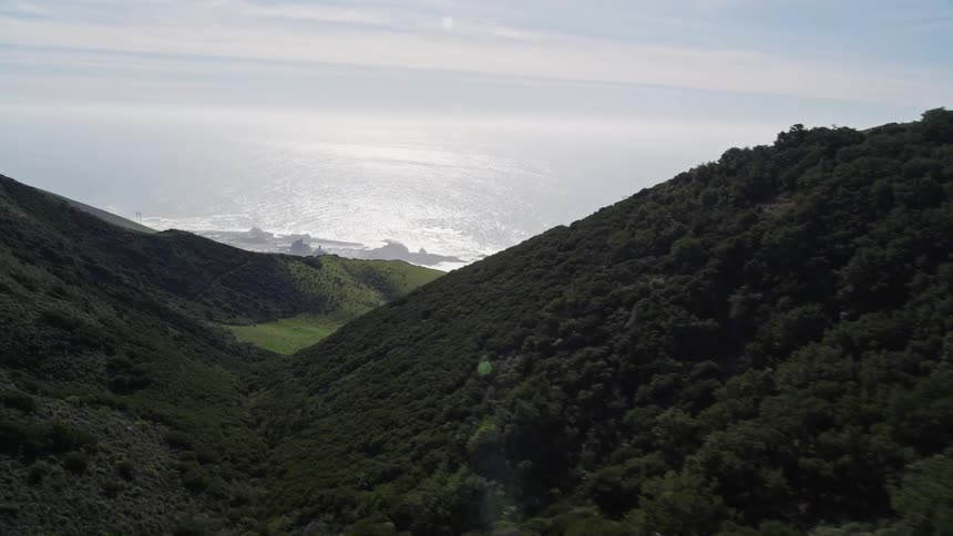 Mountains hide a coastal area with big waves