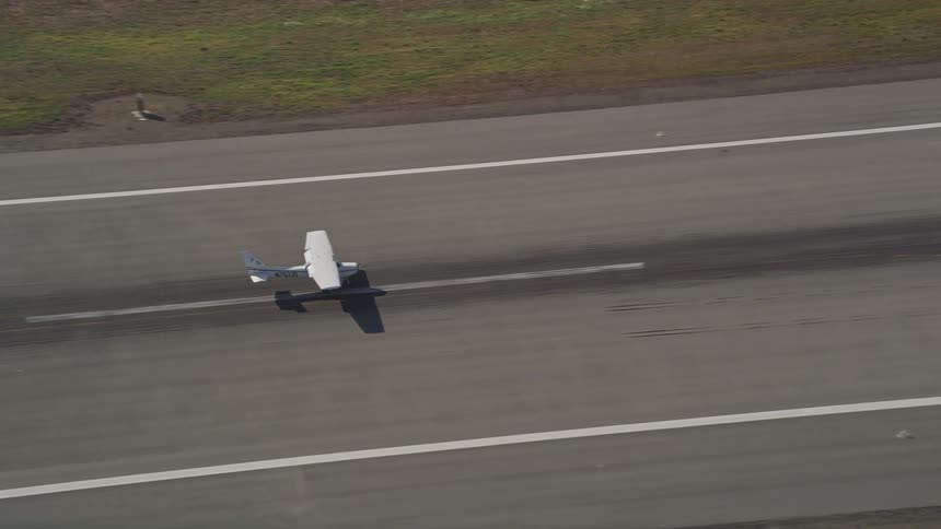 A small plane taxiing down a runway