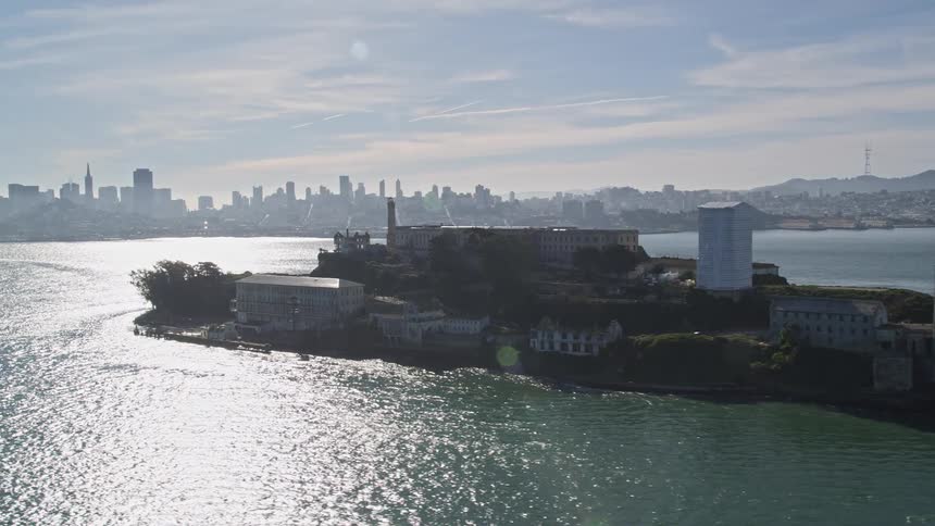 Aerial panorama of an island with urban in the middle of the sea and on the horizon a metropolis with skyscrapers