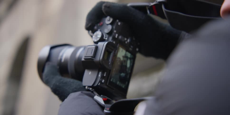 Photographer viewing images of the Zytglogge in Bern, Switzerland on a digital camera
