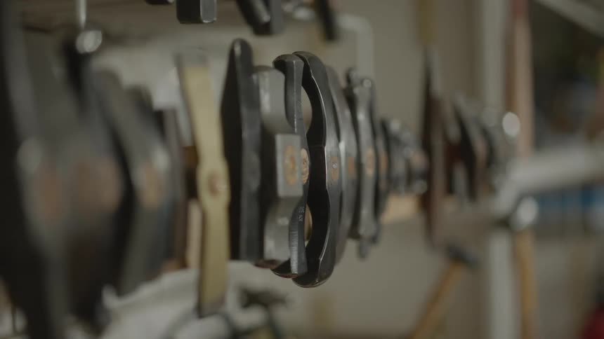 Wall shelf with hammers of different shapes