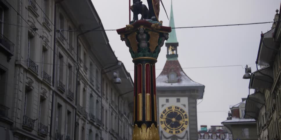 Close up view of the Zahringerbrunnen bear statue in front of the Zytglogge Tower in Bern, Switzerland