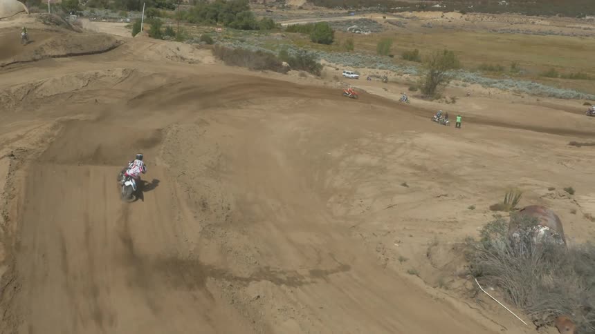 People riding dirt bikes on a dirt bike race course