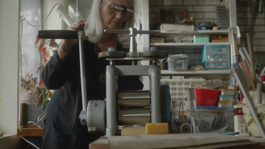 A lady operating a manual machine