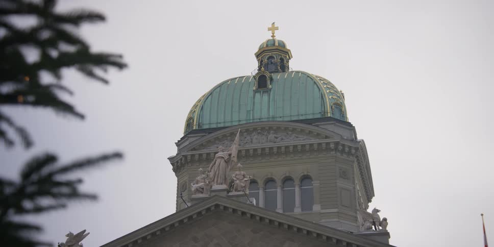 Dome of the Swiss Parliament building in Bern, Switzerland on a cloudy day