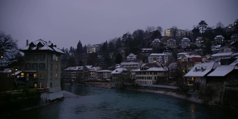 The Aare River meandering through Bern, Switzerland on a winter evening.
