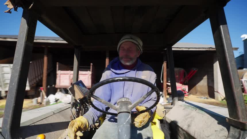 Man driving a farm tractor