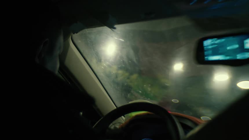 A person is driving at night