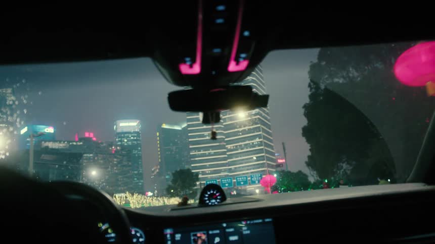 Downtown shanghai filmed from the interior of a car on a rainy night