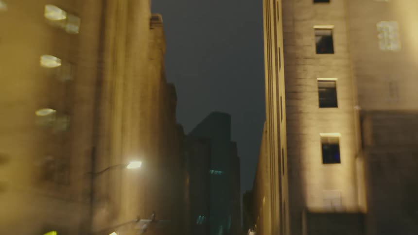 City street at night with vehicle and pedestrian traffic