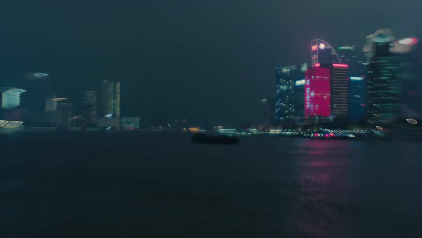 Panorama of a metropolis at night with modern skyscrapers illuminated by the sea