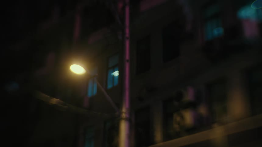 Residential suburb in buildings on a lamppost lit at night