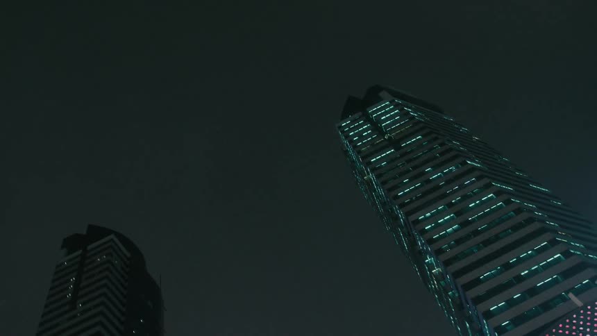 Upward view of illuminated skyscrapers at night