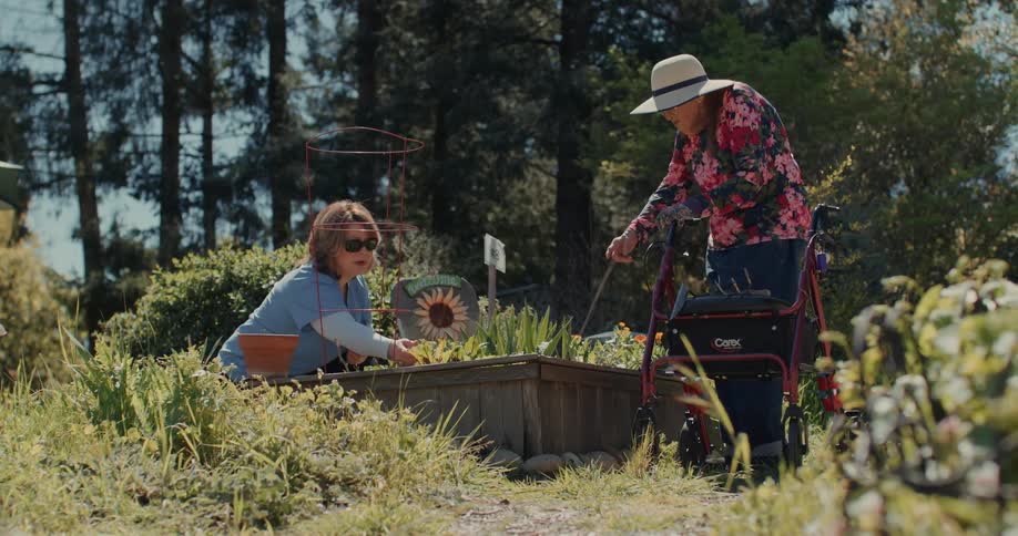 Two women are gardening by the forest