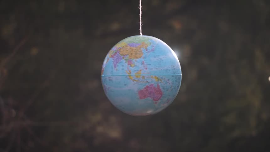 The globe is hanging from a string