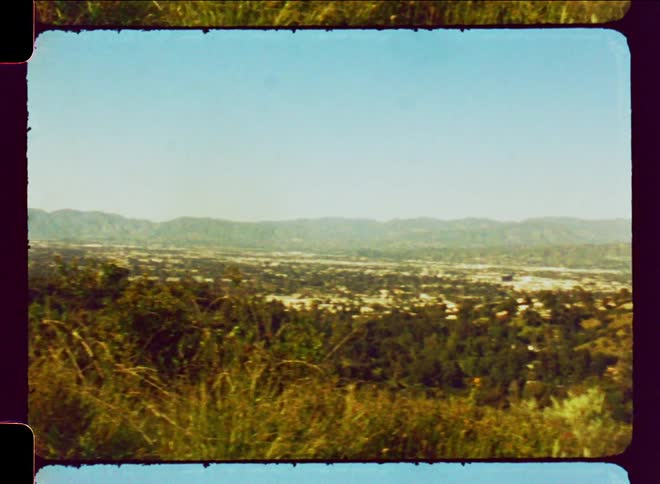 Left to right panning across rural landscape shrubery