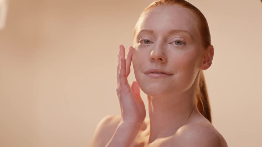 Portrait of a young blueeyed redhead woman modeling