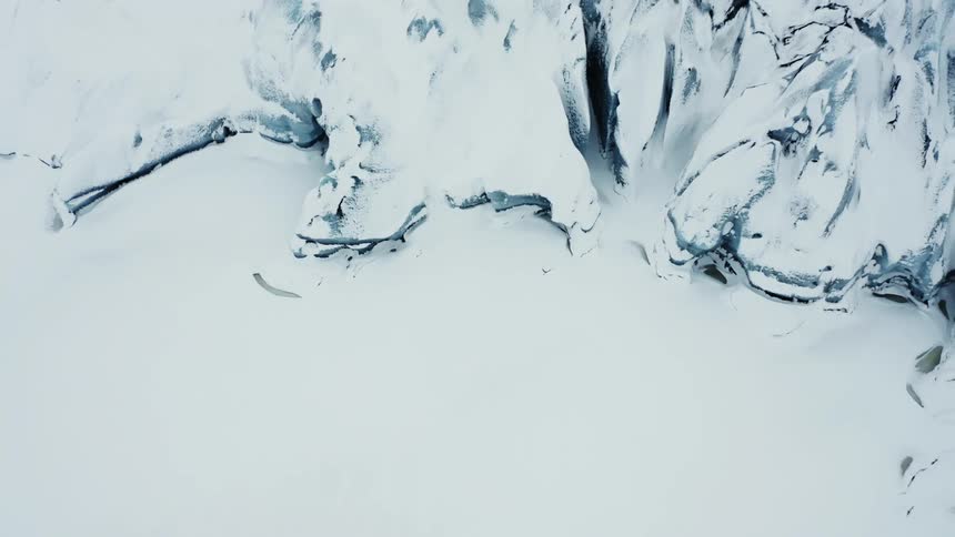 Aerial panorama of snowcapped white mountains