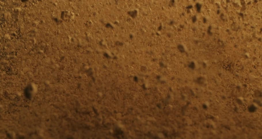 Abstract powder texture in extreme closeup bouncing from an explosion and falling in slow motion