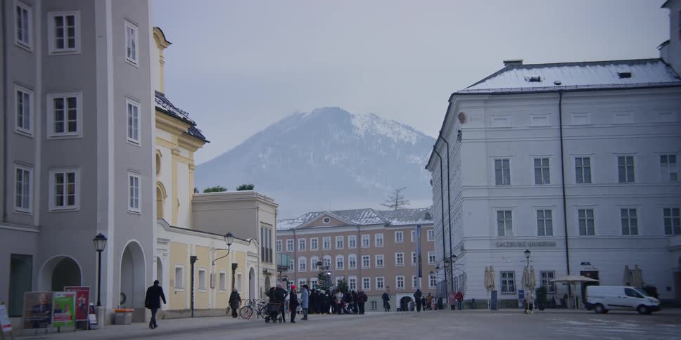 Street near St. Michaels Church and Salzburg Museum in Salzburg, Austria with mountain view