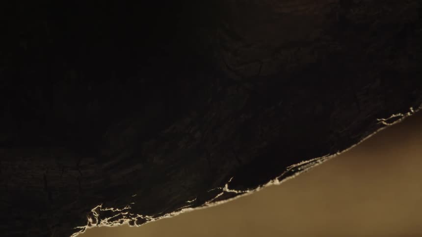 Extreme closeup on an abstract rock rotating in slow motion