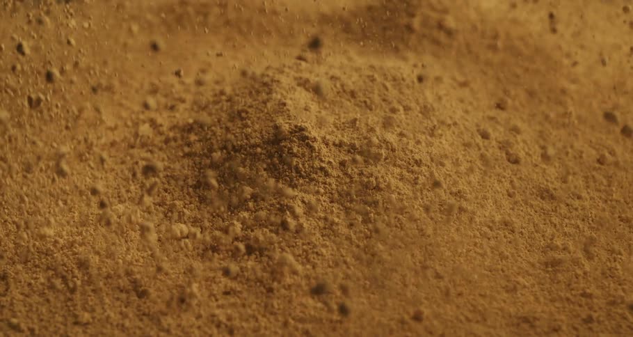 Close up of sand particles jumping up