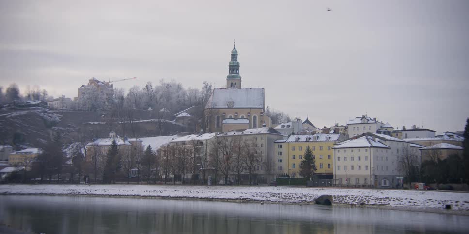 View of Mullner Kirche along the Salzach River in Salzburg, Austria