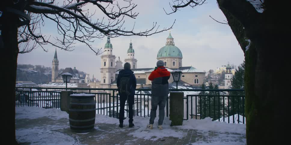 A couple of tourists viewing the Salzburg cathedral in Austria