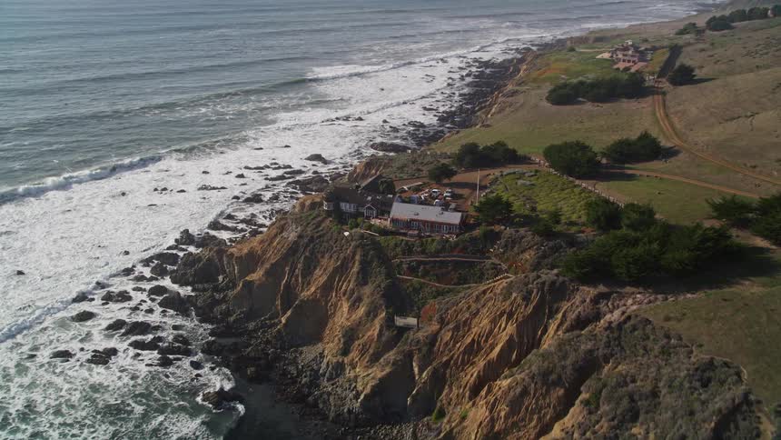Aerial panorama of a hotel on the cliff of a rocky seaside coast