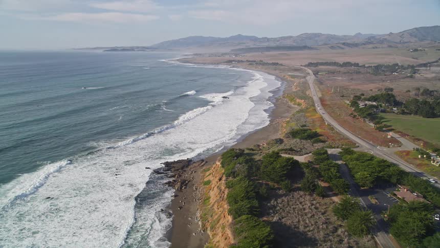 Traffic drives on a coastal road
