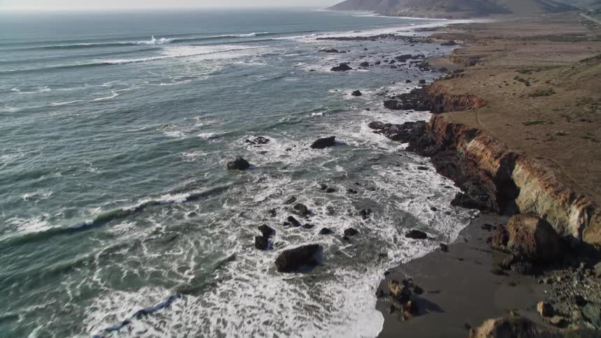 Aerial panorama of a peninsula with the rocky coast and a vast blue sea